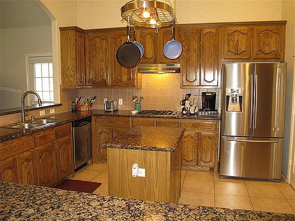 A chef's dream kitchen!  Tons of cabinetry for storage & ample counter space add to the delightful flow of this kitchen!
