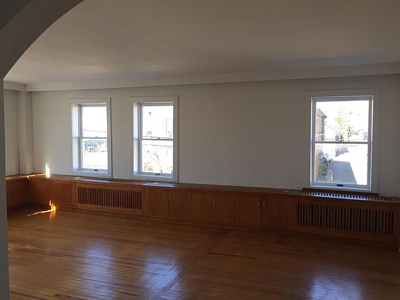 LARGE LIVING ROOM WITH CUSTOM BUILT-INS PROVIDING LOTS OF STORAGE