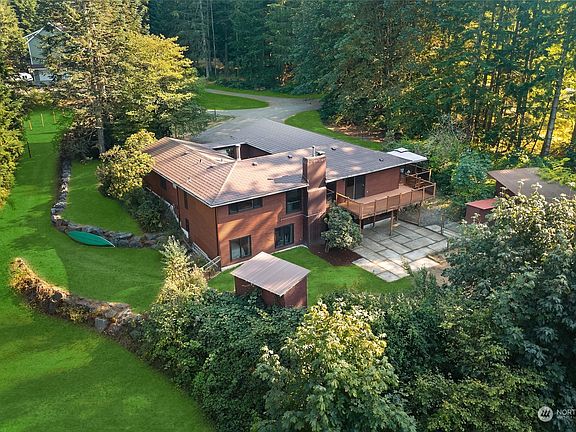 The back of the house, showing the larger deck and the patio.  This is the last house on the road!  Terrific privacy.>