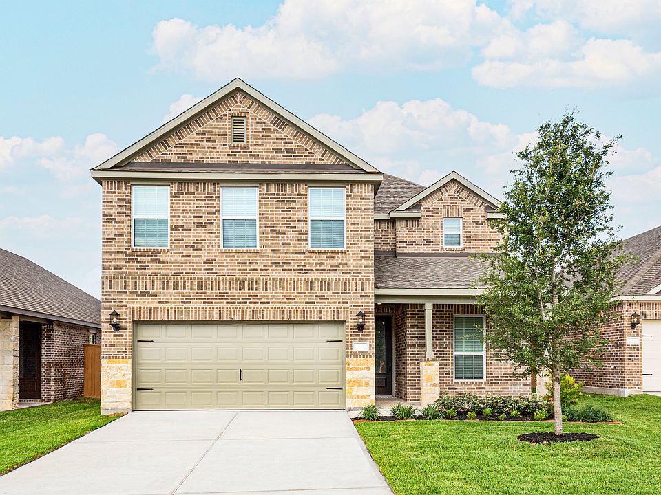 This beautiful two-story home has brick and stone and front yard landscaping