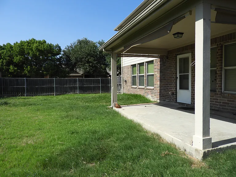 Backyard with covered porch.