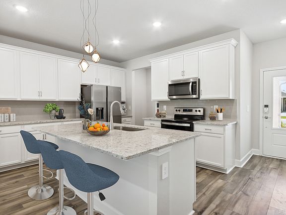 Kitchen with microwave, dishwasher, stove, oven, refrigerator and dining nook