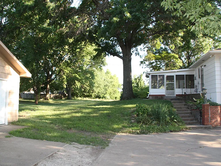 Stairwell to rear east backing screened porch off living room. Plus rear entry to mud room/laundry room.