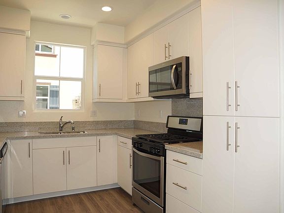 White Thermofoil kitchen cabinets , sink with a view & large pantry!