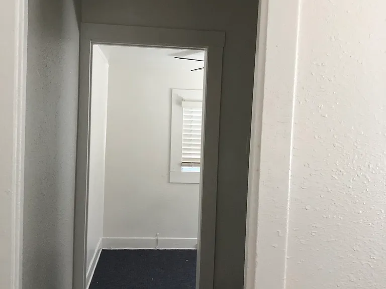 Hallway to closet and bedroom 2