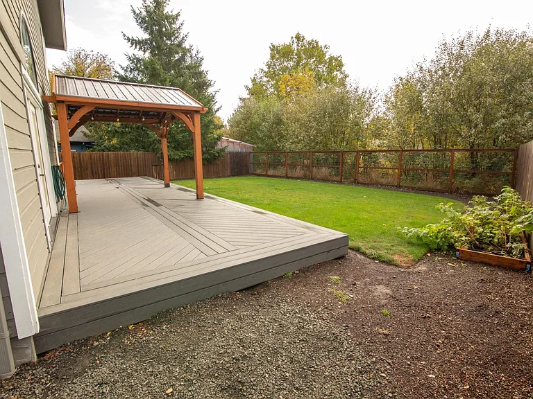 View of the backyard (backs up to a small creek) and back deck-great for outdoor living!
