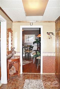 Come on into the foyer. On the right you have many built in's, straight ahead you have formal dining area and to the left is the living room.