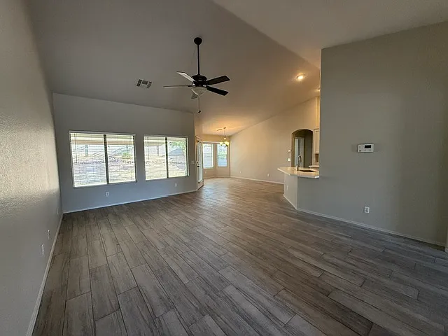 Great room, breakfast nook, kitchen and expansive backyard views.