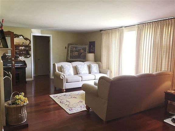 LIVING ROOM - Large open space with wood burning fireplace to the left and open door to bedrooms straight ahead.  Large picture 