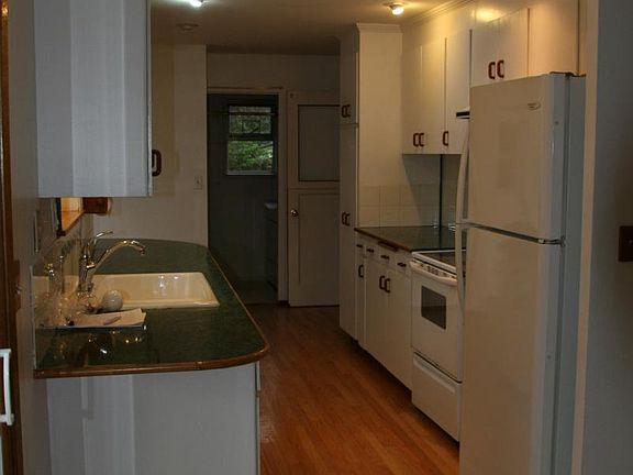 Kitchen from dining room w/laundry room at the end (note: re