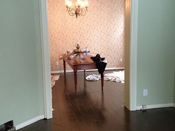 High ceilings and painted chocolate brown floors.