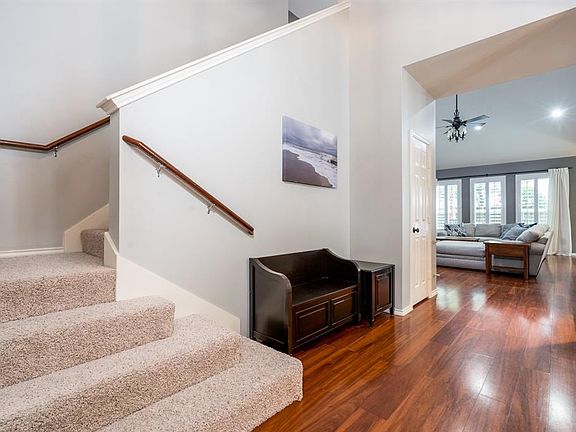 A two story entry way is light and bright, as beautiful wood flooring flows down the hall, into the study, formal dining room, family room and primary suite.