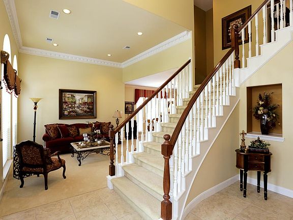Lovely open entry with grand staircase, and art niche....plenty of room to greet your guests.
