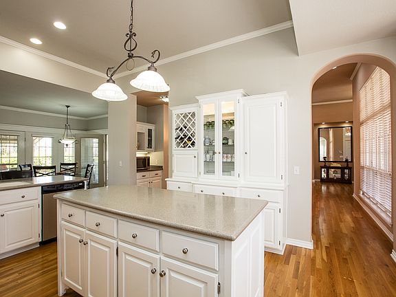 Rich hardwood floors integrate seamlessly into the open Kitchen.