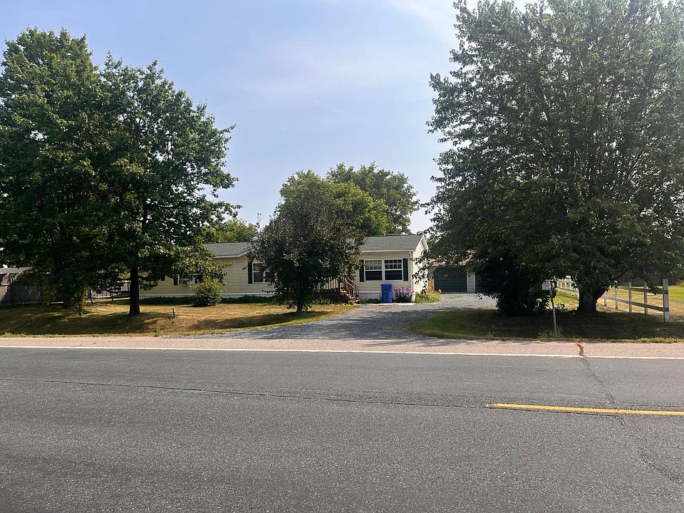 Front of the house, crushed granite driveway leads to the 2 car plus garage.