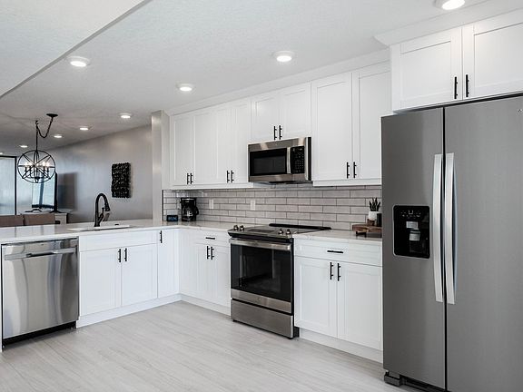 New large and small appliances in kitchen