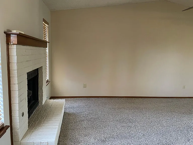 Front room, view of fireplace from back door