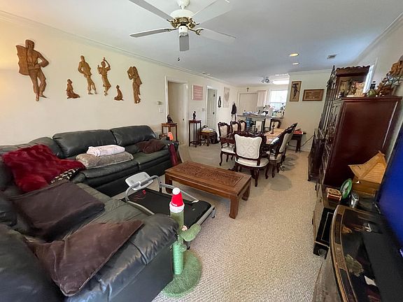 Living area with a wide angle lease lookinto kitchen with a peninsula bar.