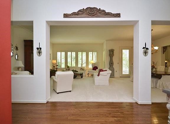 Wood floors and pristine cozy carpet welcome you inside, where a wall of shuttered windows reveal the sensational golf course views.