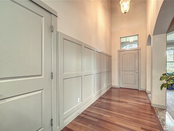 2 Story Entry, Lovely Wainscotting, Beautiful Cumaru Hardwood & Marble Flooring... Archways and columns frame the formal living 
