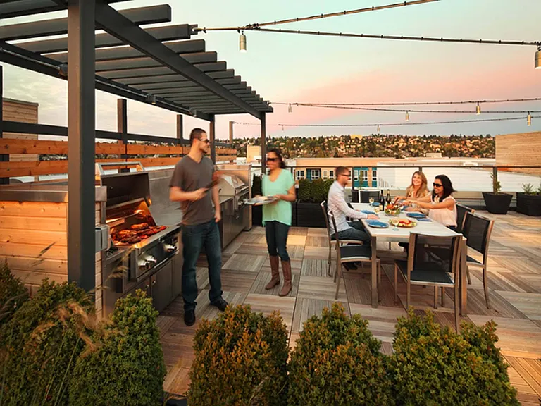 Grill and dine with friends on the rooftop, enjoying great food and stunning views in a lively outdoor setting.