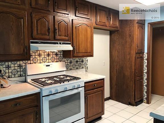 Cabinetry and backsplash tile in nice condition.   Gas range, tile floor