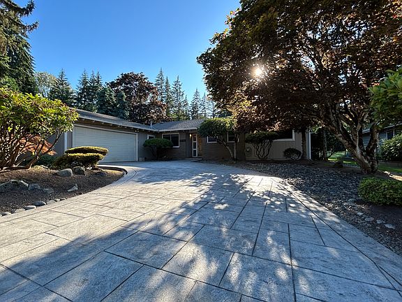 Front of house with mature land scape.