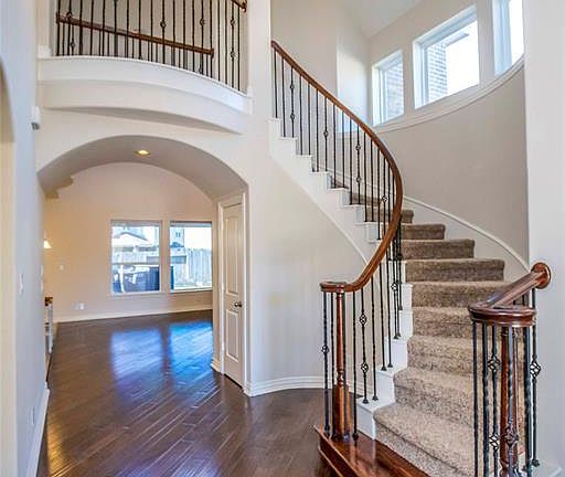 This view upon entering the front door shows the gorgeous wood laminate floors and spiral staircase with upgraded spindles.