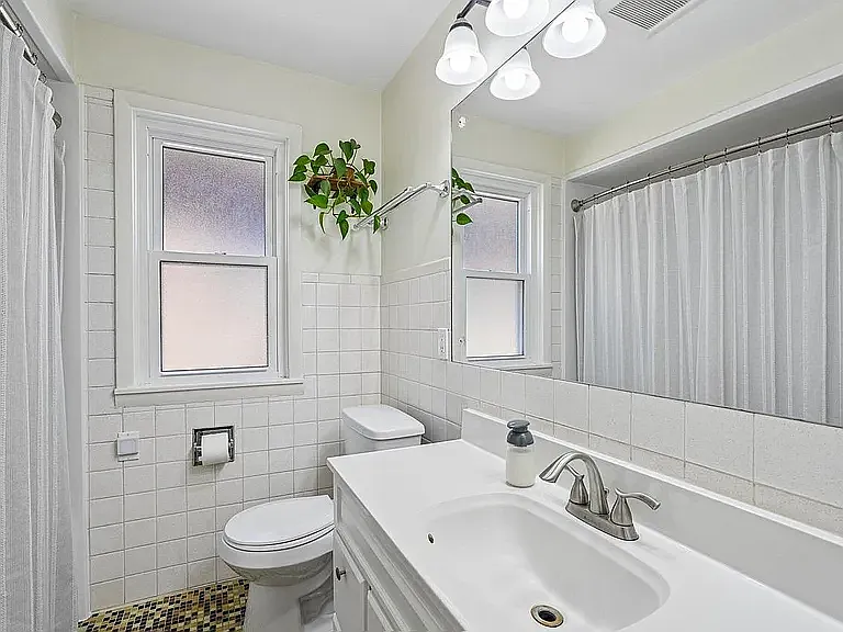 Well-kept, tiled bathroom.
