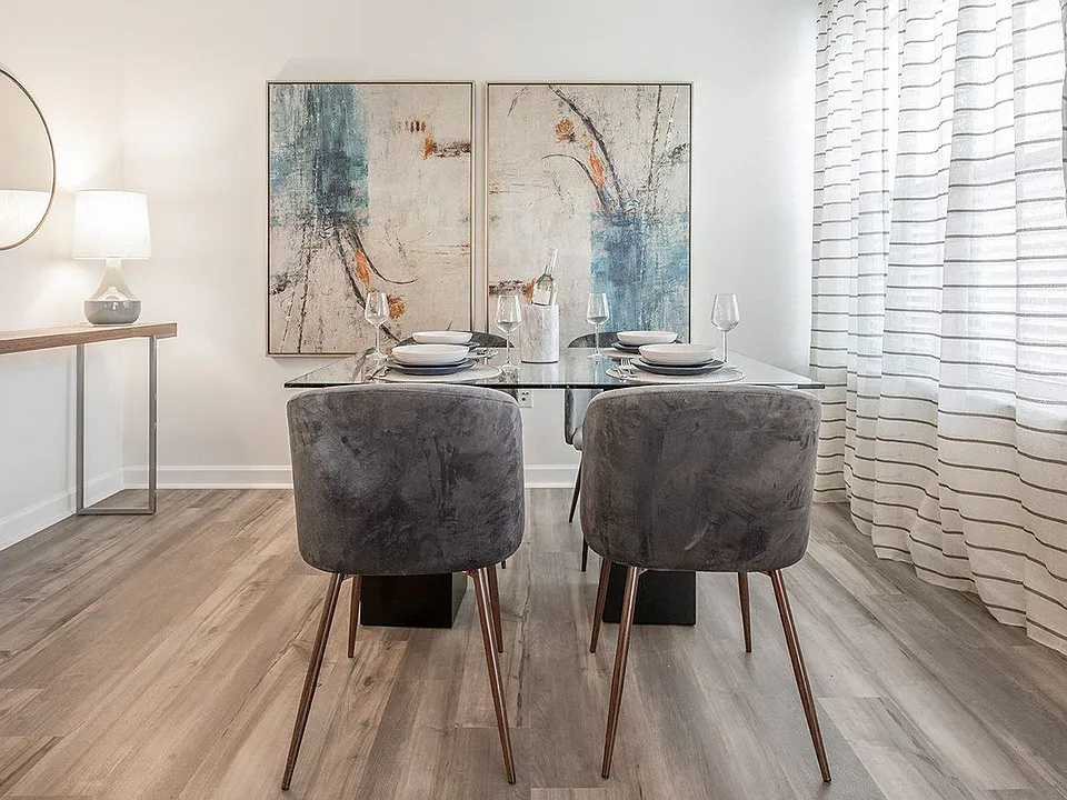 The dining area gets its own space, right beside a curtained window.