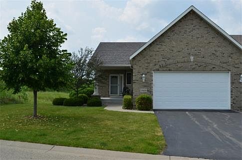 High quality finishes in this rambler-style end unit townhome include Andersen windows, maple floors
