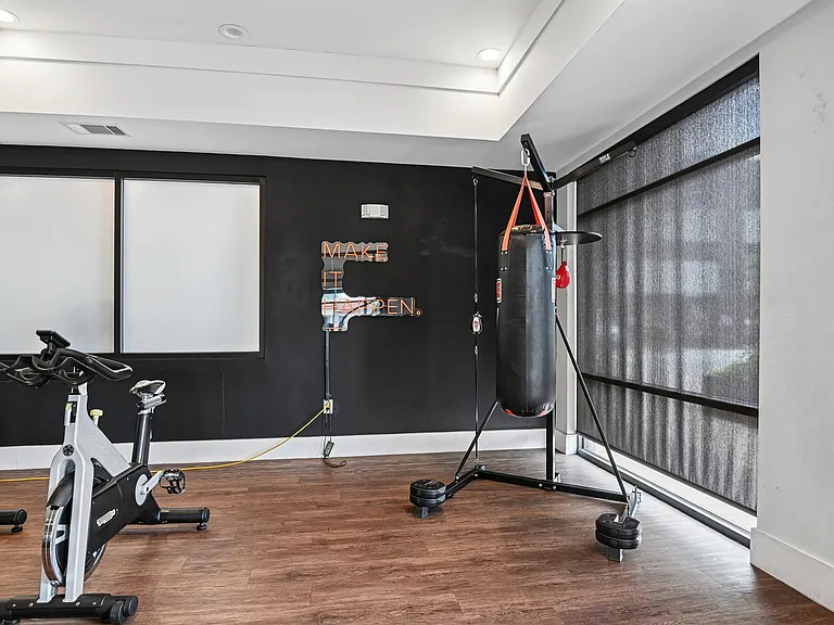 Markethaus 3700 Athletic Club Boxing Bag Free Standing A gym with a punching bag, exercise bikes