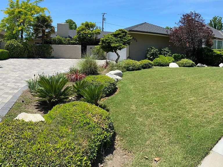 Front view. Landscaped yard and new pavers. Home is set back for more privacy and quiet.