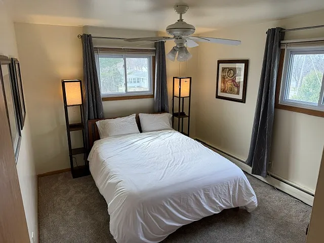 Bedroom #1 with new mattress, blackout curtains, blinds, lamps, dresser, closet
