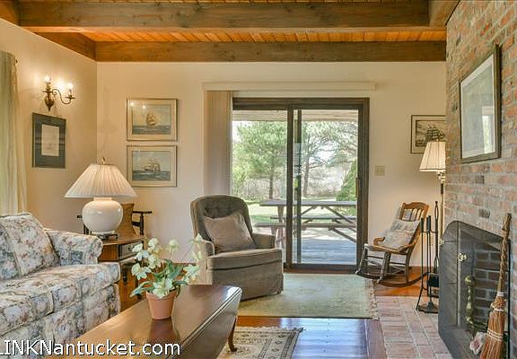 Living room with wood burning fireplace.