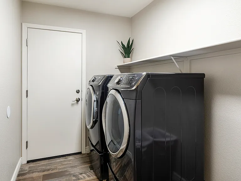 Laundry room with washer and dryer. Enter the garage from here.