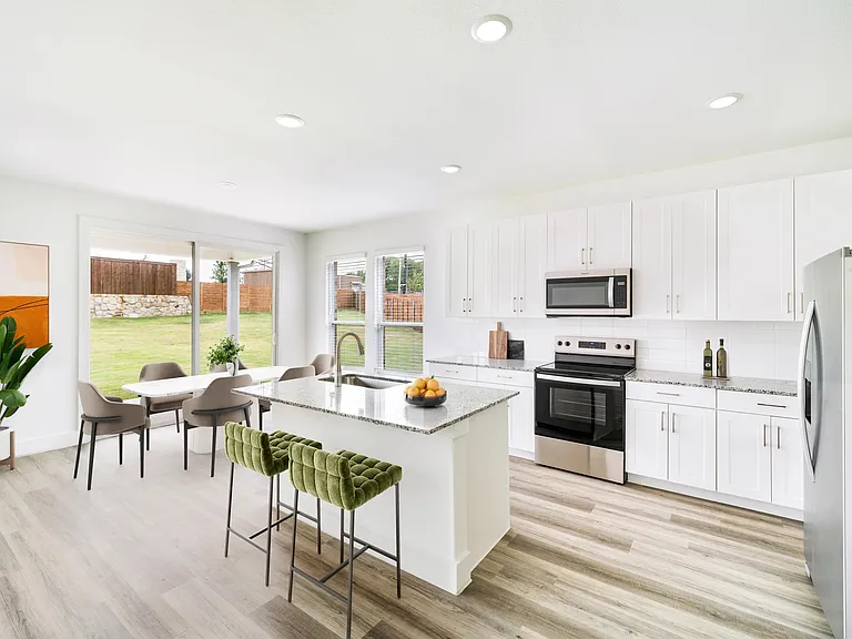 Bright and inviting, this Amavi Celina kitchen offers seamless access to a spacious backyard and covered patio perfect for relaxed Texas evenings.