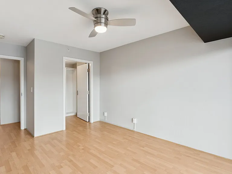 Bedroom 1 with balcony and custom walk-in closet.