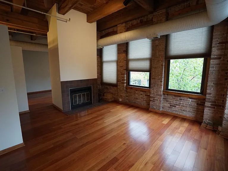 Living Room area / Wood Burning Fireplace partition to bedroom