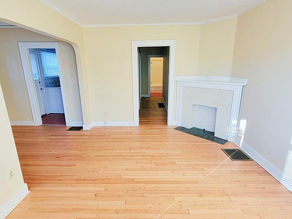 Living room with view into kitchen and hallway