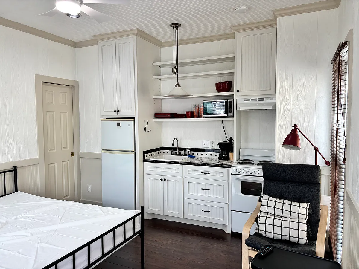 View from the entrance. Fully stocked kitchenette. Chair for relaxing or studying. Full size bed with memory foam mattress. - 1618 Church St