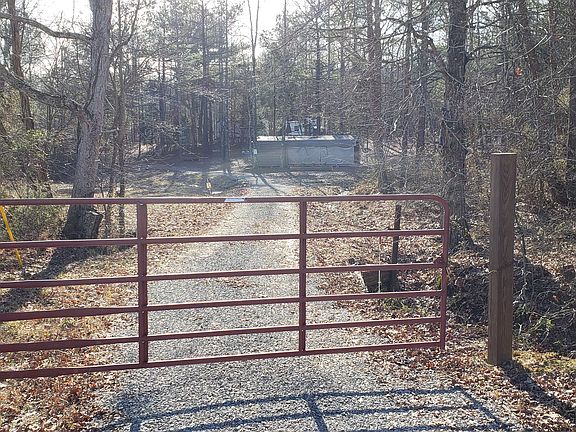 Locked gate at tree line