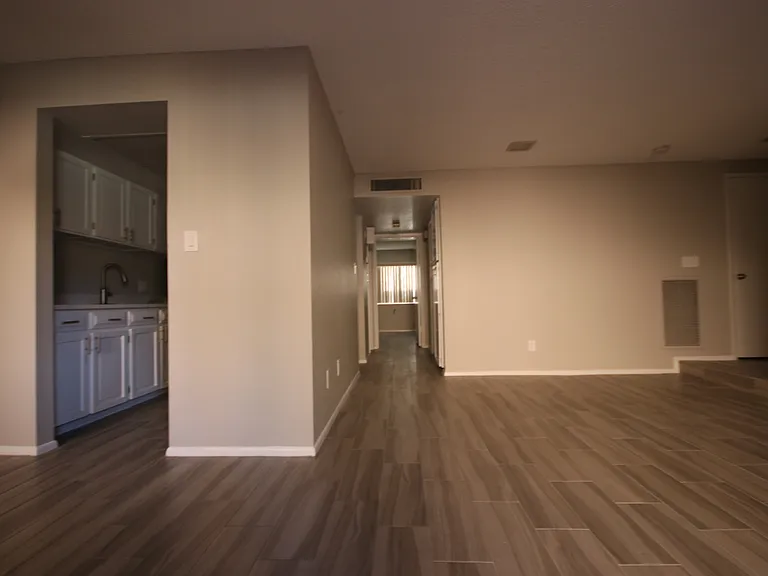 Your view from your living area at the entrance and into kitchen, and the hallway to 2 bathrooms and 2 bedrooms. Have a 2nd look at the staging pics for the living and dining areas!