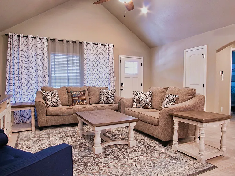 Comfortable open-concept living room flowing seamlessly into the dining area and kitchen.