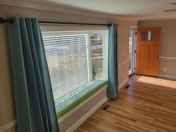 Bench seat in living room 93"' x 18" with custom cushion and curtains.