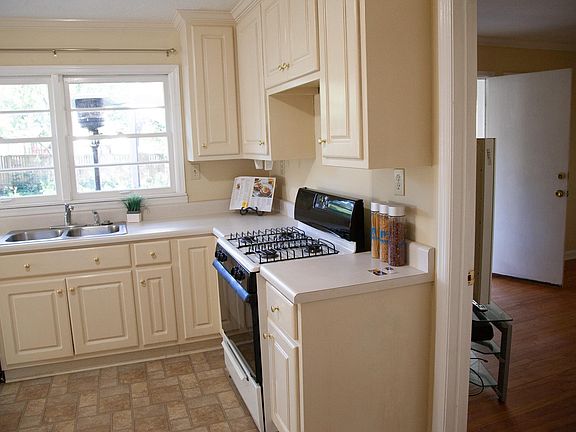 Large kitchen with gas stove and double sink.
