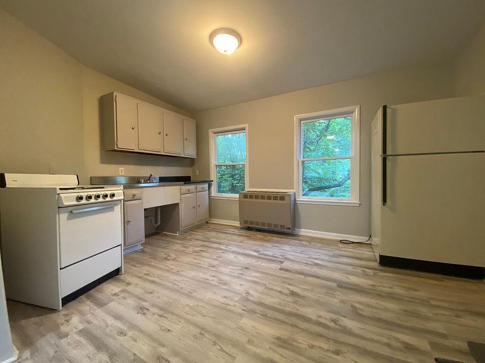 Kitchen with old stove/fridge. Since replaced with stainless steel stove/fridge. See photos