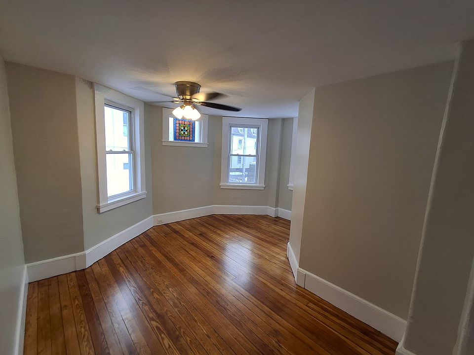 Dining Room: Refinished hardwood flooring, brand-new ceiling fan, original stained-glass window.