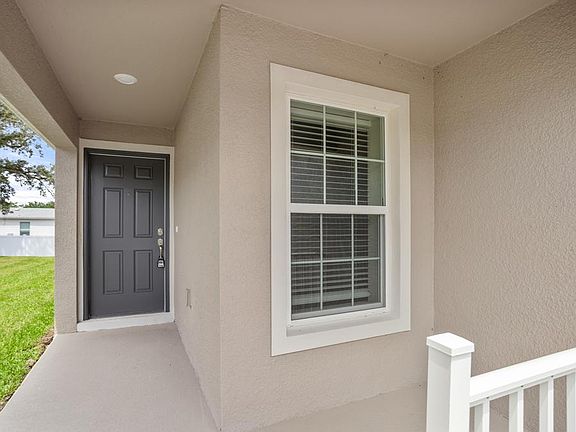 A covered front porch welcomes you inside - Begonia by Highland Homes