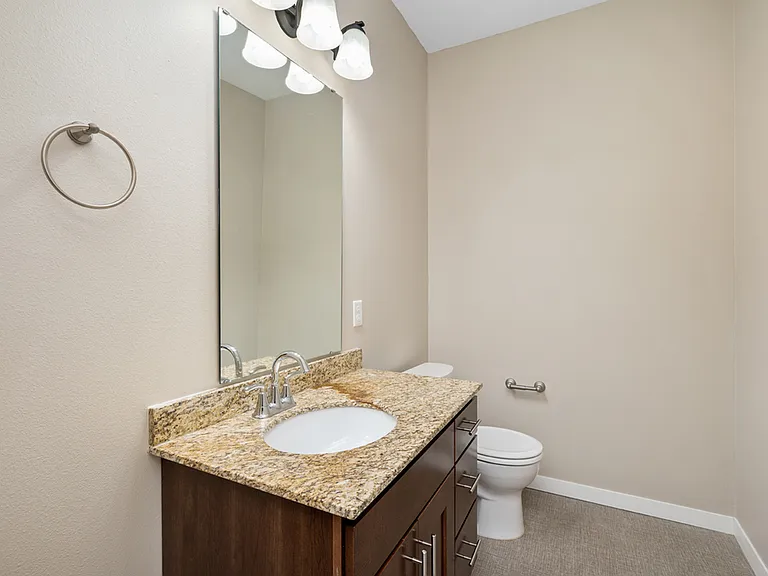 Elegant bathroom with granite countertop, large mirror, and modern fixtures, offering a luxurious and clean design. Elegant bathroom with granite countertop, large mirror, and modern fixtures, offering a luxurious and clean design.